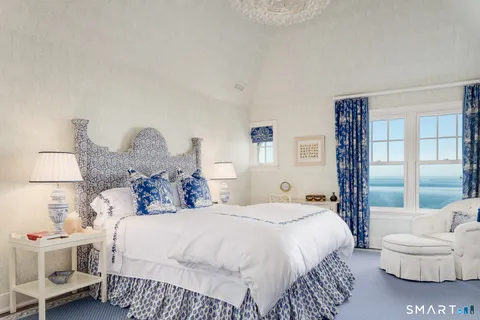 a bedroom with a large bed and a large window