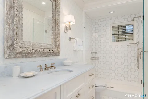a large white kitchen with a large window