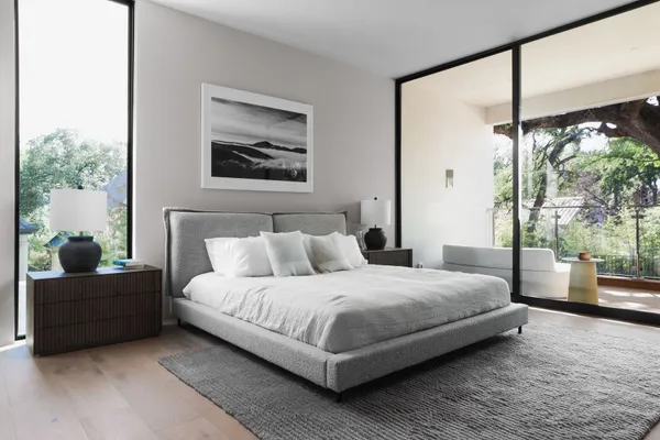 a bedroom with a bed and lamp