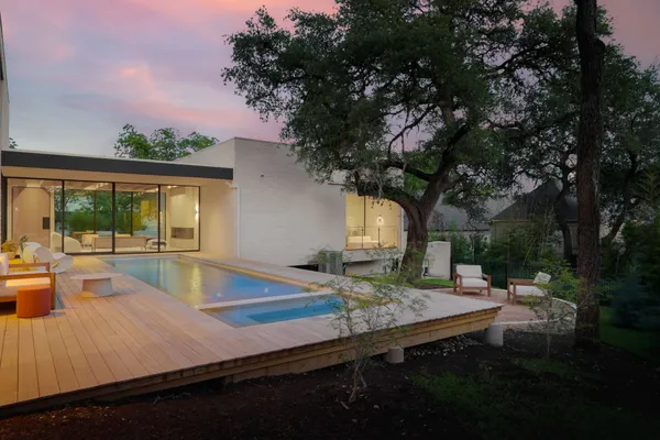 a view of a backyard with sitting area and lake view