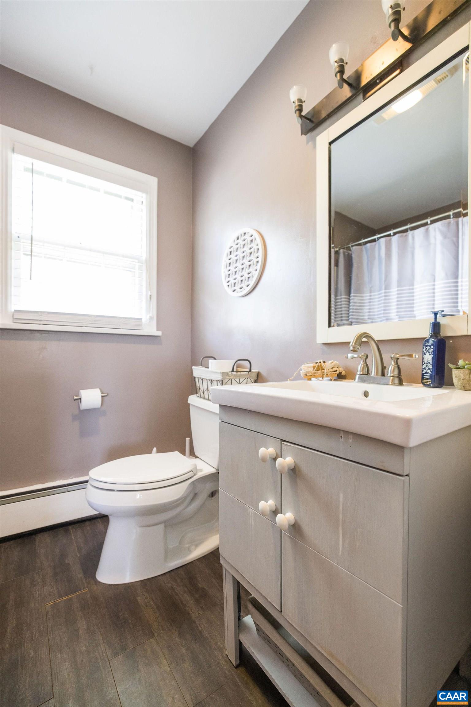 5374 Gordonsville Road Keswick, VA 22947 - Photo 18 of 35 a bathroom with a toilet a sink and a window
