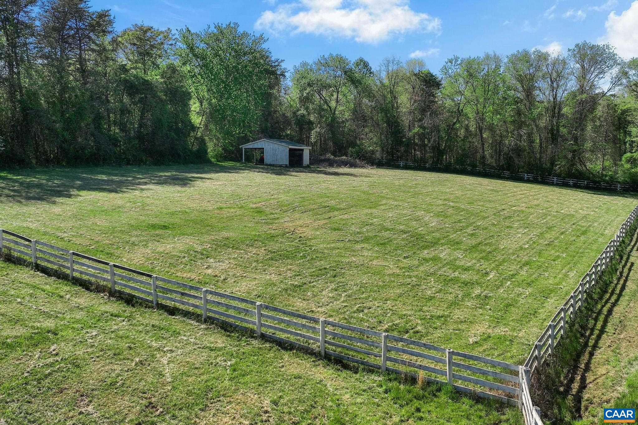 5374 Gordonsville Road Keswick, VA 22947 - Photo 19 of 35 a view of a garden with a bench in the background