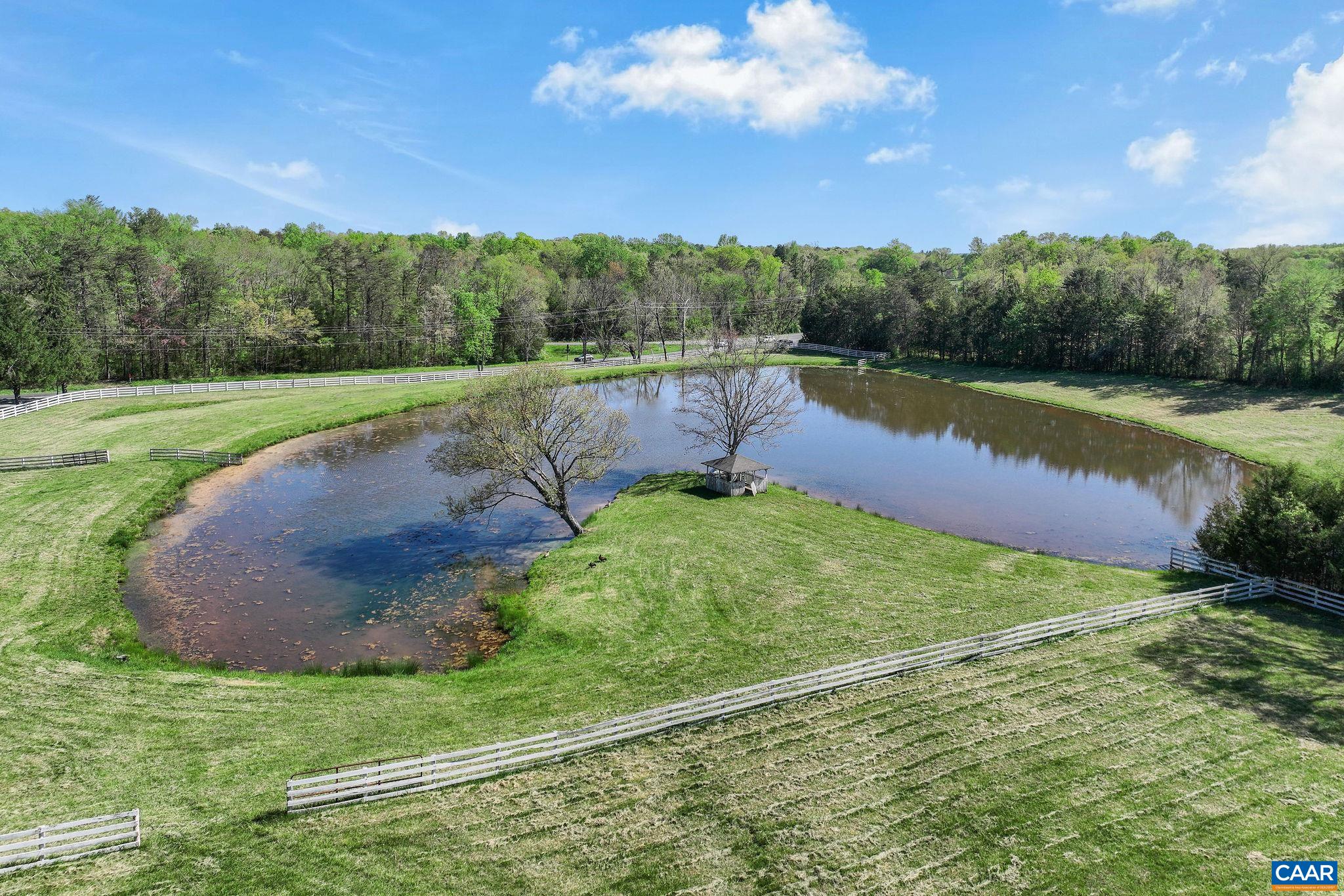 5374 Gordonsville Road Keswick, VA 22947 - Photo 25 of 35 a view of a lake with a yard