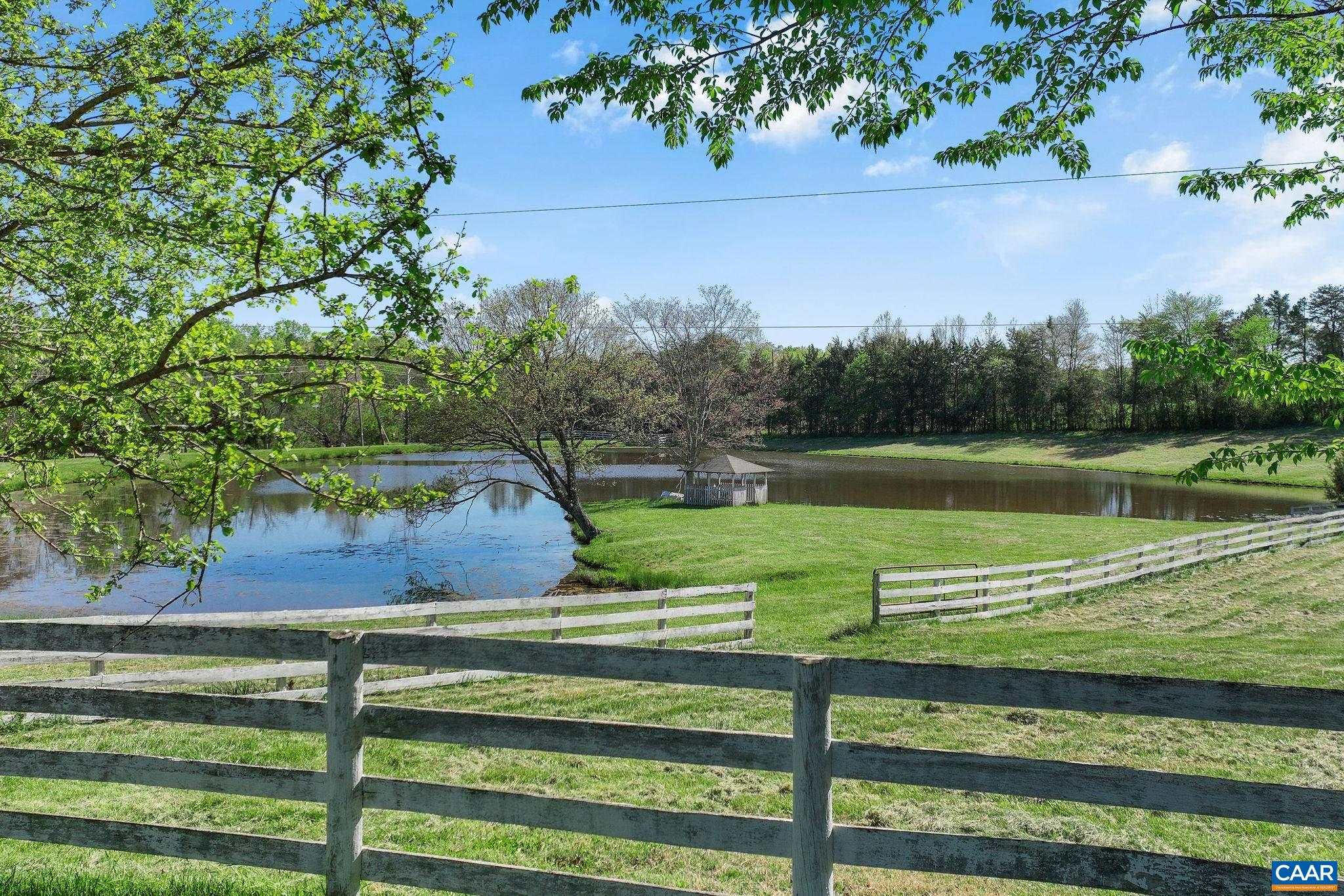 5374 Gordonsville Road Keswick, VA 22947 - Photo 33 of 35 a view of a park with a bench and a lake view