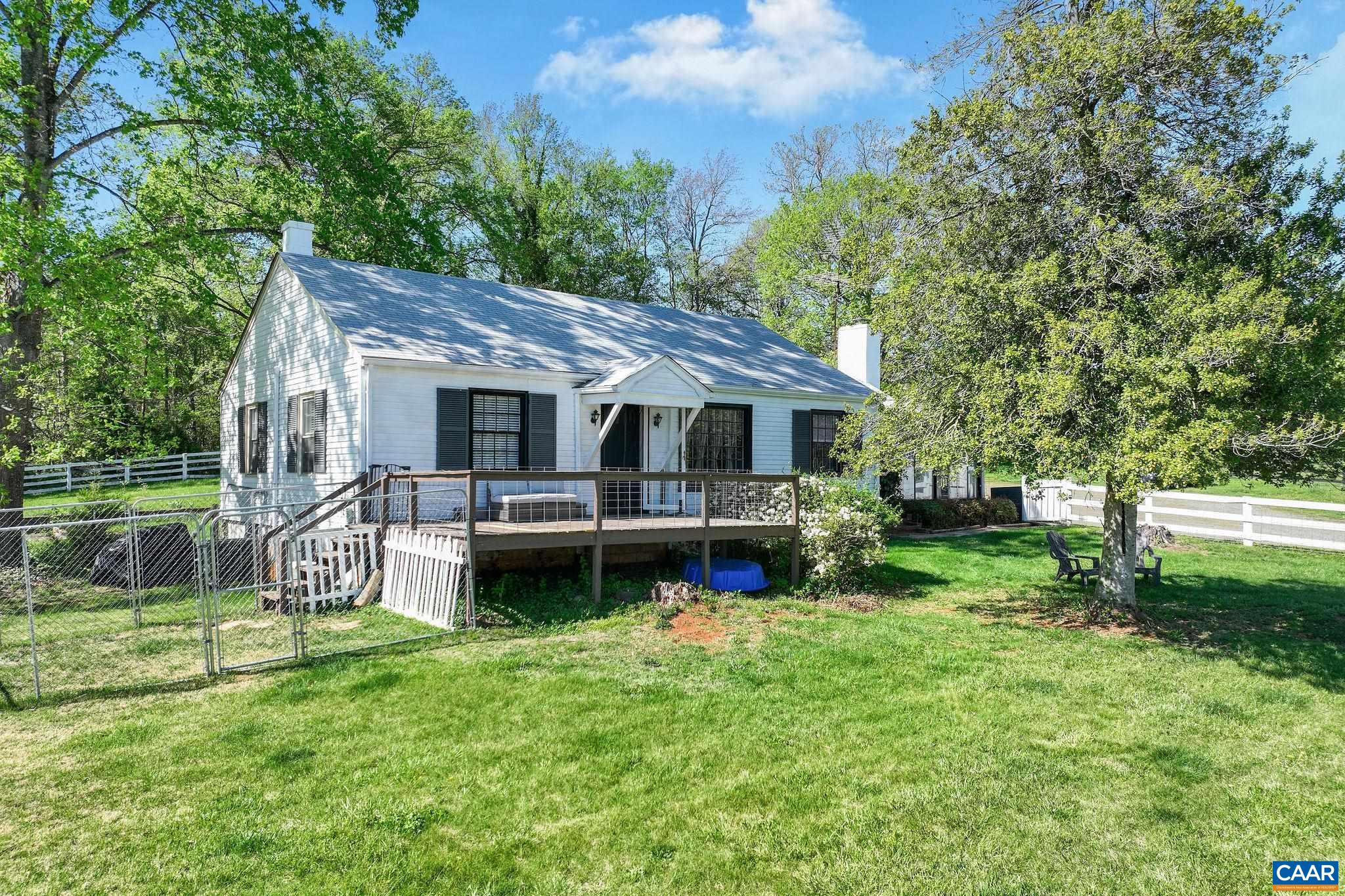 5374 Gordonsville Road Keswick, VA 22947 - Photo 7 of 35 a view of a house with a yard deck and a large tree