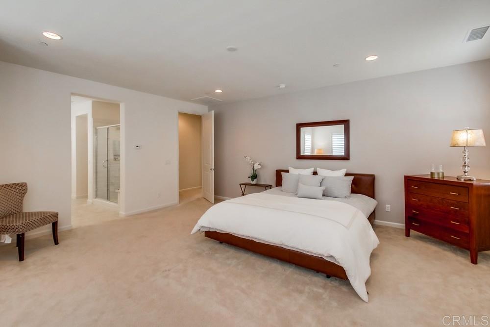 13413 Red Oak Way San Diego, CA 92130 - Photo 14 of 25 a spacious bedroom with a bed and a lamp