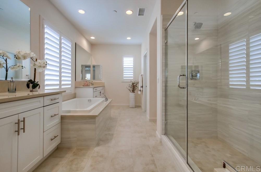 13413 Red Oak Way San Diego, CA 92130 - Photo 15 of 25 a bathroom with a granite countertop sink a toilet and shower