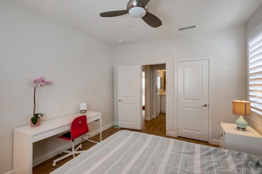 13413 Red Oak Way San Diego, CA 92130 - Photo 18 of 25 a bedroom with a bed and a chandelier