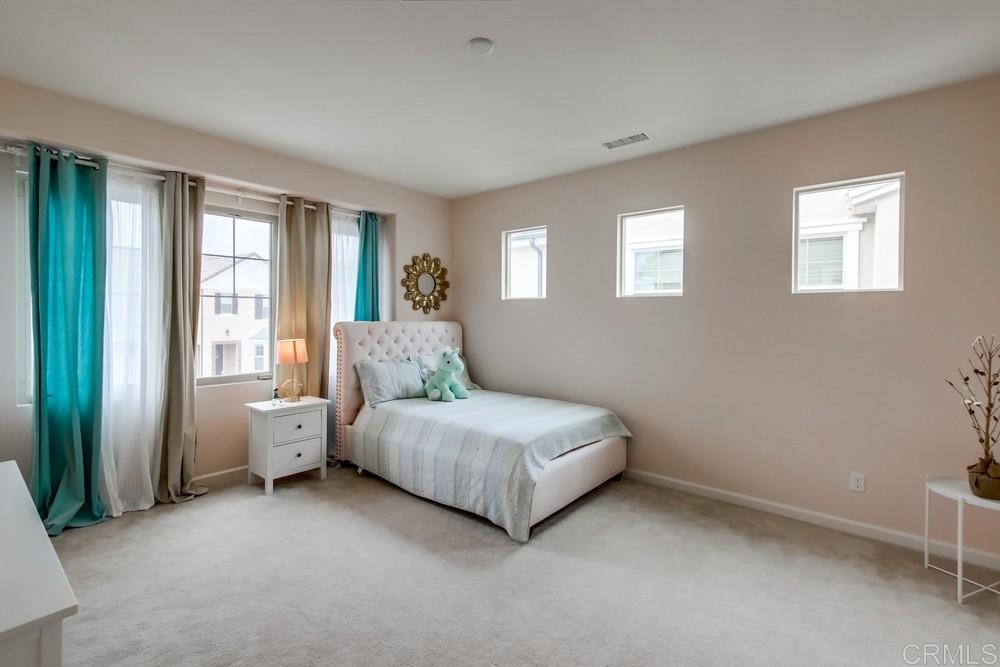 13413 Red Oak Way San Diego, CA 92130 - Photo 19 of 25 a spacious bedroom with a bed and a window