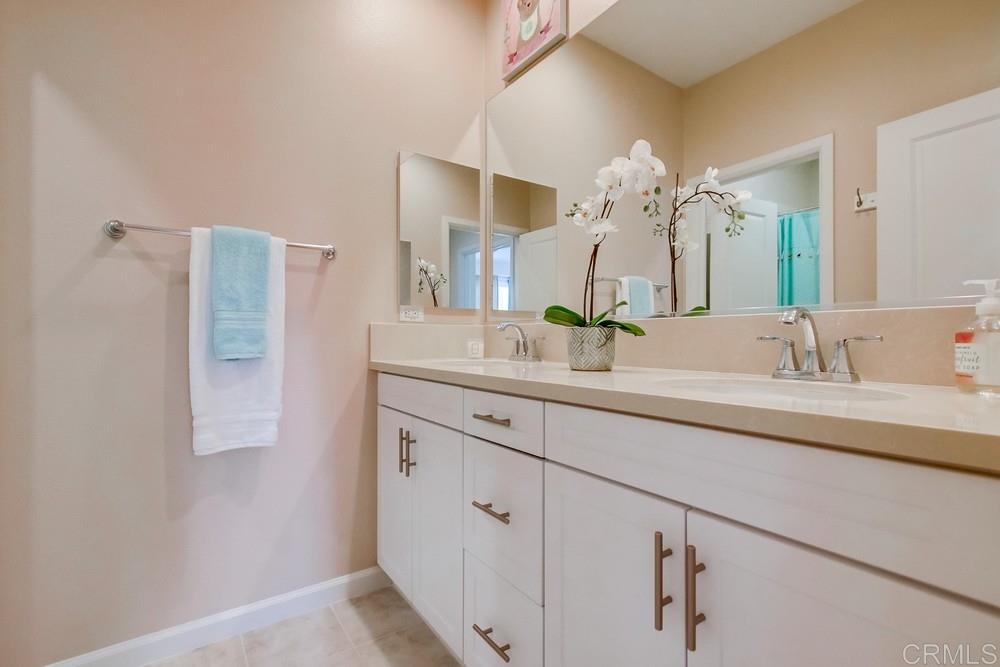 13413 Red Oak Way San Diego, CA 92130 - Photo 21 of 25 a bathroom with a double vanity sink mirror and shower