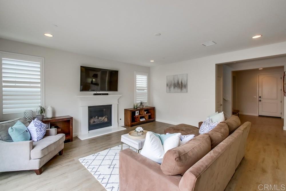 13413 Red Oak Way San Diego, CA 92130 - Photo 4 of 25 a living room with furniture a fireplace and a flat screen tv