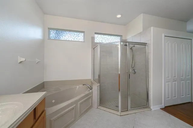 a bathroom with a tub shower and sink