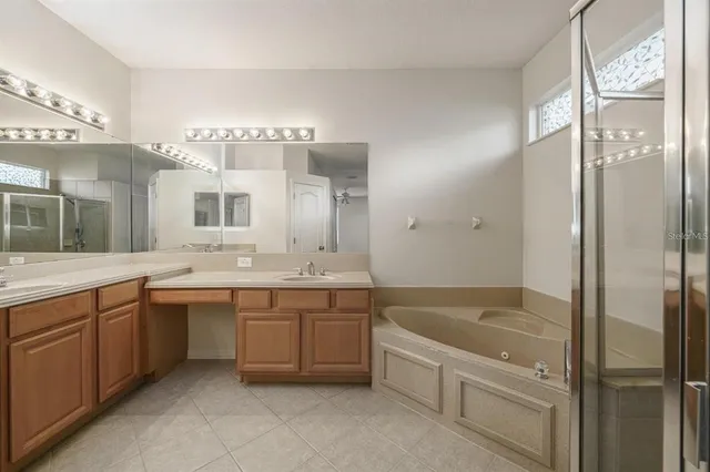 a bathroom with a tub sink and mirror