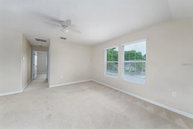 an empty room with windows and closet