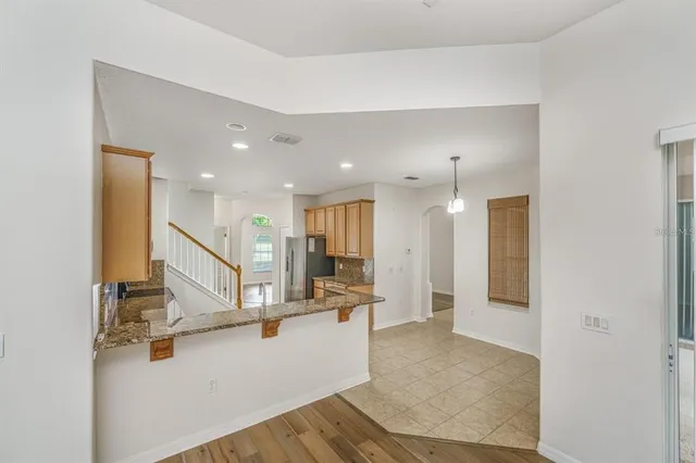 a view of a living room and kitchen with furniture