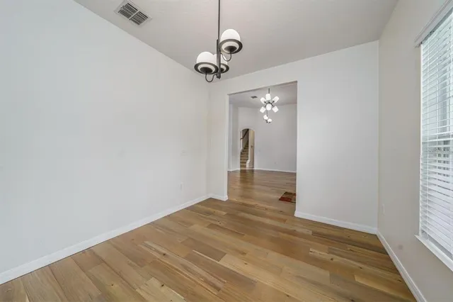a view of a room with wooden floor and windows