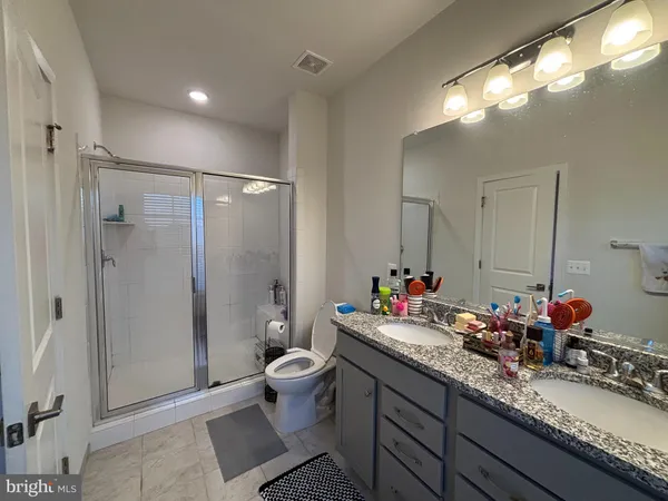 a bathroom with a granite countertop sink mirror and double