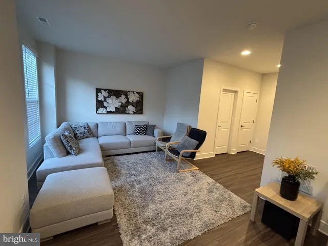 a living room with furniture and a rug