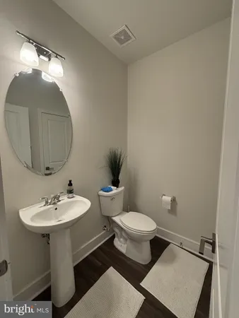 a bathroom with a sink toilet and a mirror