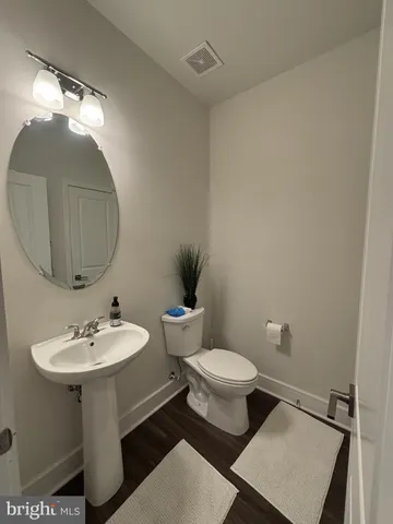 a bathroom with a sink toilet and a mirror