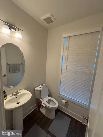 a bathroom with a sink mirror and toilet