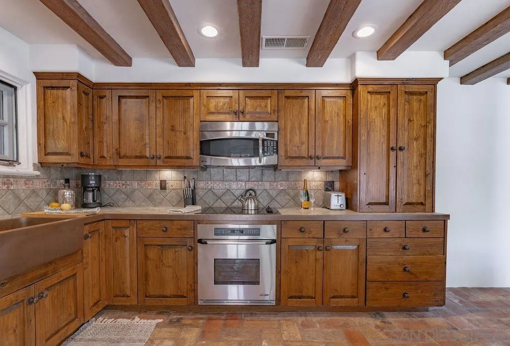 17116 Paseo Hermosa, Unit A Rancho Santa Fe, CA 92067 - Photo 11 of 47 a kitchen with stainless steel appliances granite countertop a sink and a stove