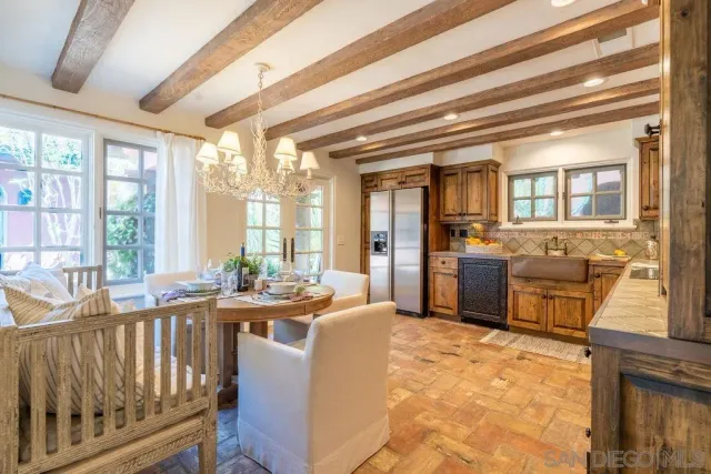 a dining room with wooden floor and a floor to ceiling window