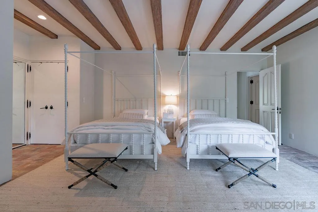 17116 Paseo Hermosa, Unit A Rancho Santa Fe, CA 92067 - Photo 20 of 47 a bedroom with a bed and a chandelier