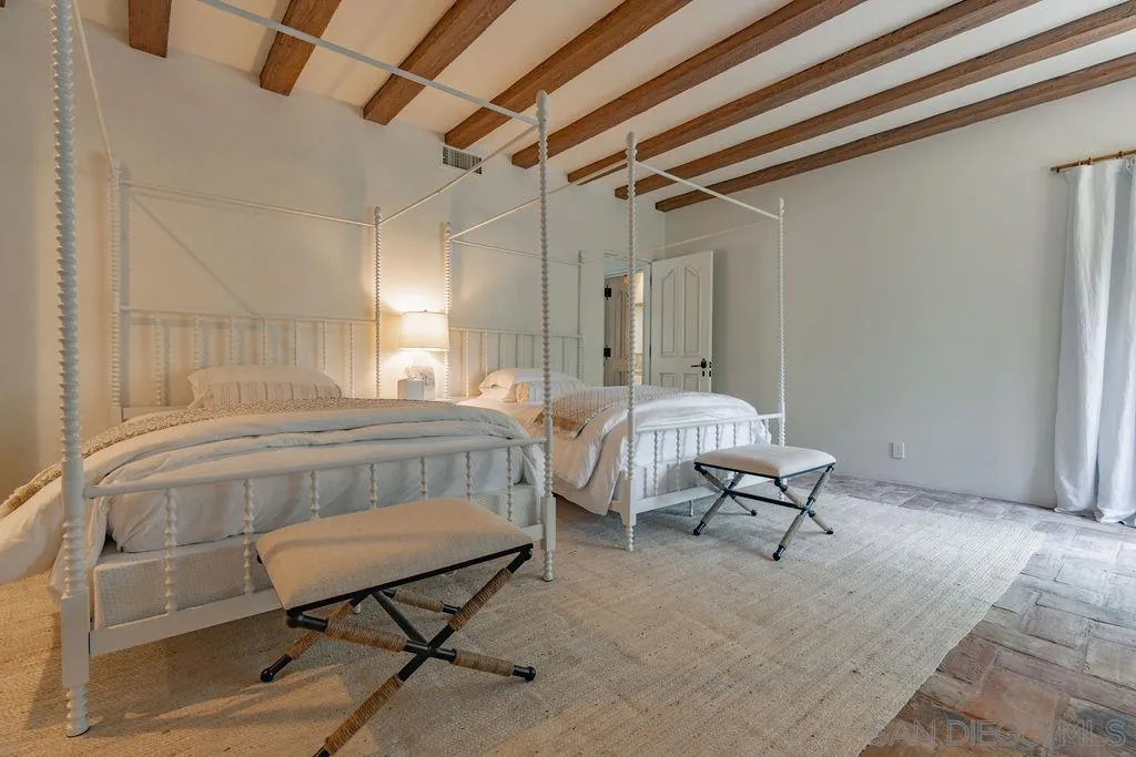 17116 Paseo Hermosa, Unit A Rancho Santa Fe, CA 92067 - Photo 21 of 47 a bedroom with a bed chair and a window