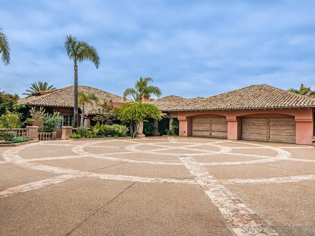 17116 Paseo Hermosa, Unit A Rancho Santa Fe, CA 92067 - Photo 35 of 47 a front view of a house with a yard and palm trees