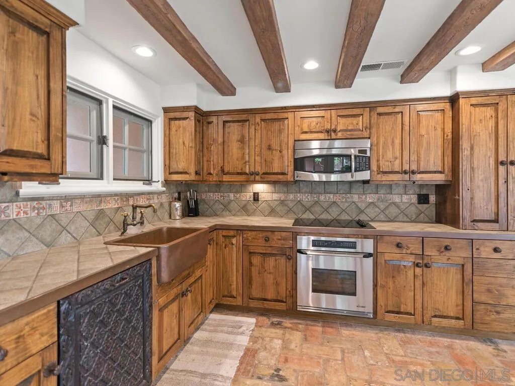 17116 Paseo Hermosa, Unit A Rancho Santa Fe, CA 92067 - Photo 7 of 47 a kitchen with stainless steel appliances granite countertop a sink stove and cabinets
