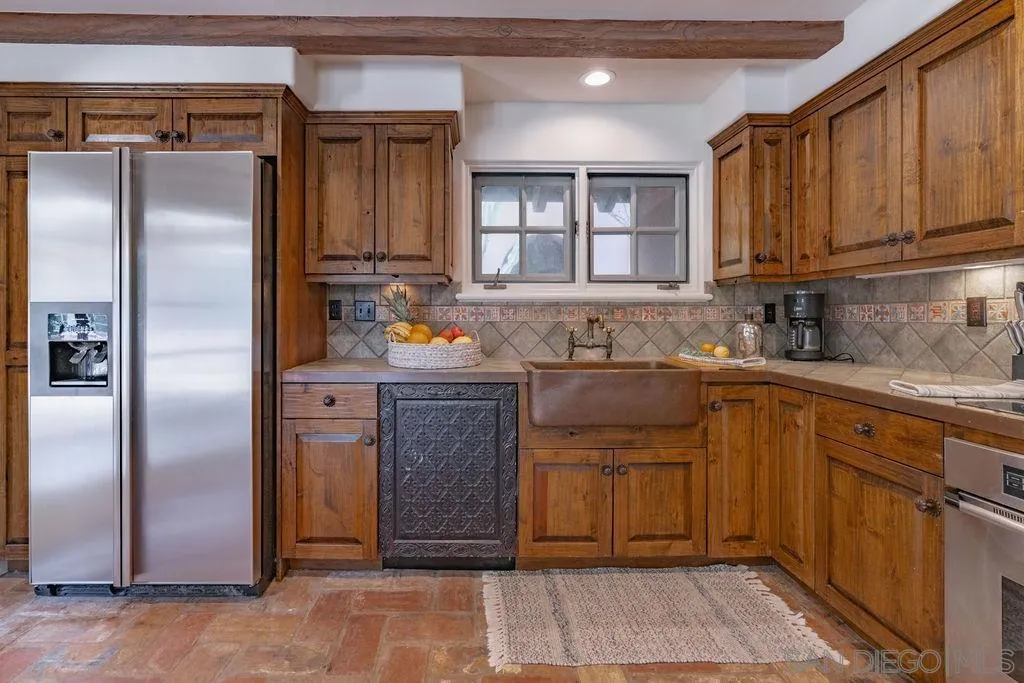 17116 Paseo Hermosa, Unit A Rancho Santa Fe, CA 92067 - Photo 9 of 47 a kitchen with stainless steel appliances granite countertop a refrigerator and a sink