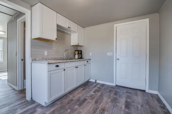 a view of a kitchen with closet and wooden floor