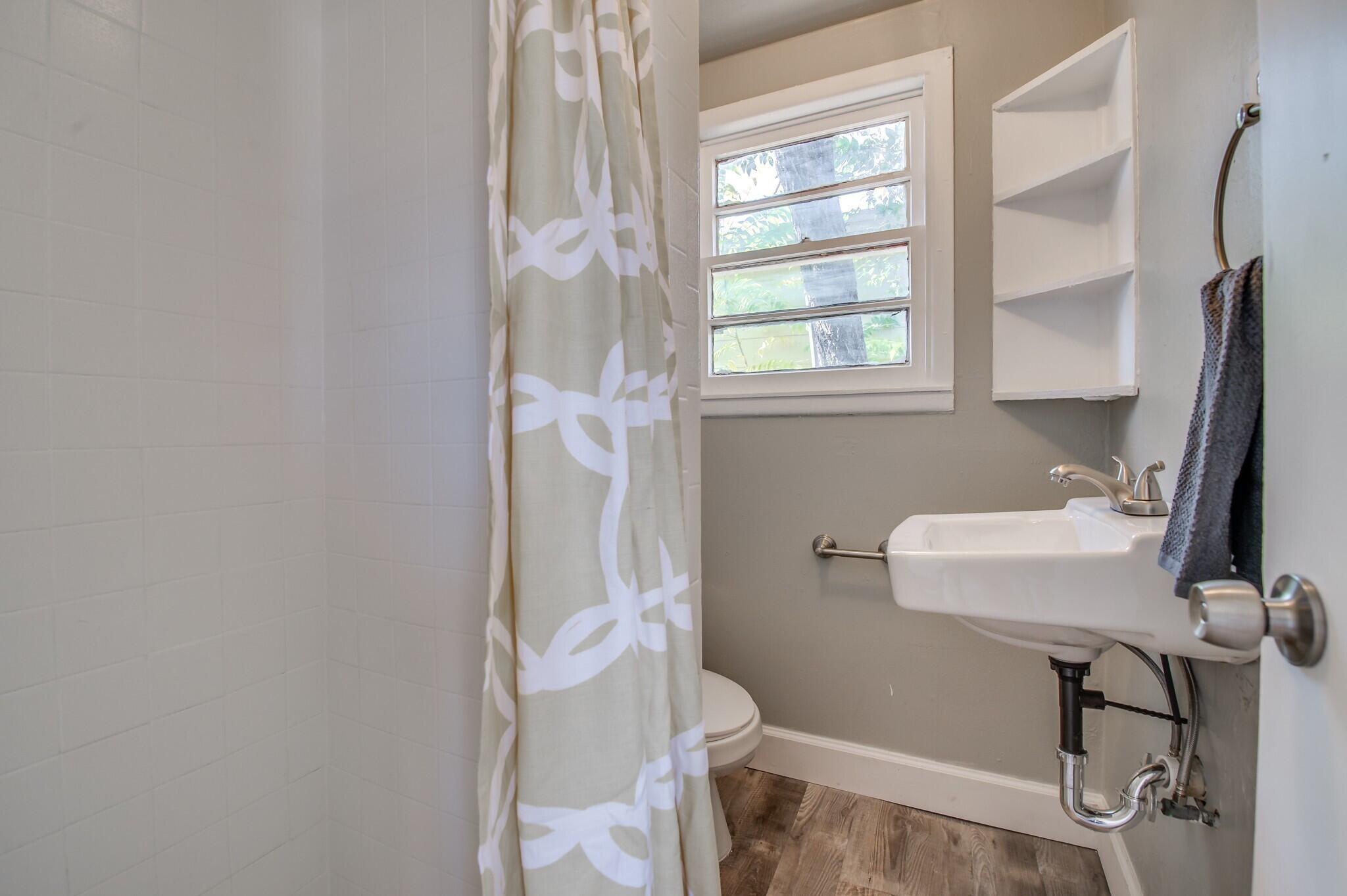4813 40th Street, Unit REAR Lubbock, TX 79414 - Photo 7 of 7 a bathroom with a sink and a mirror