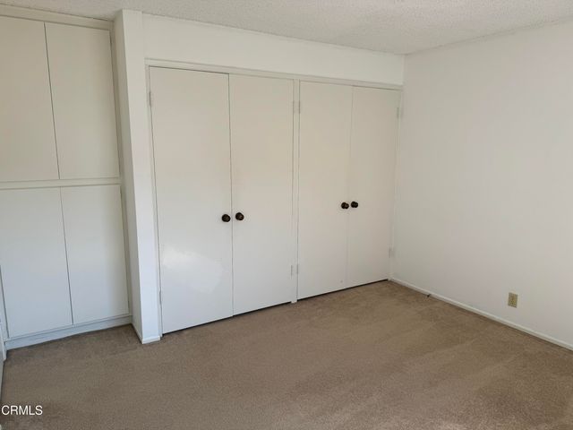 an empty room with closet area