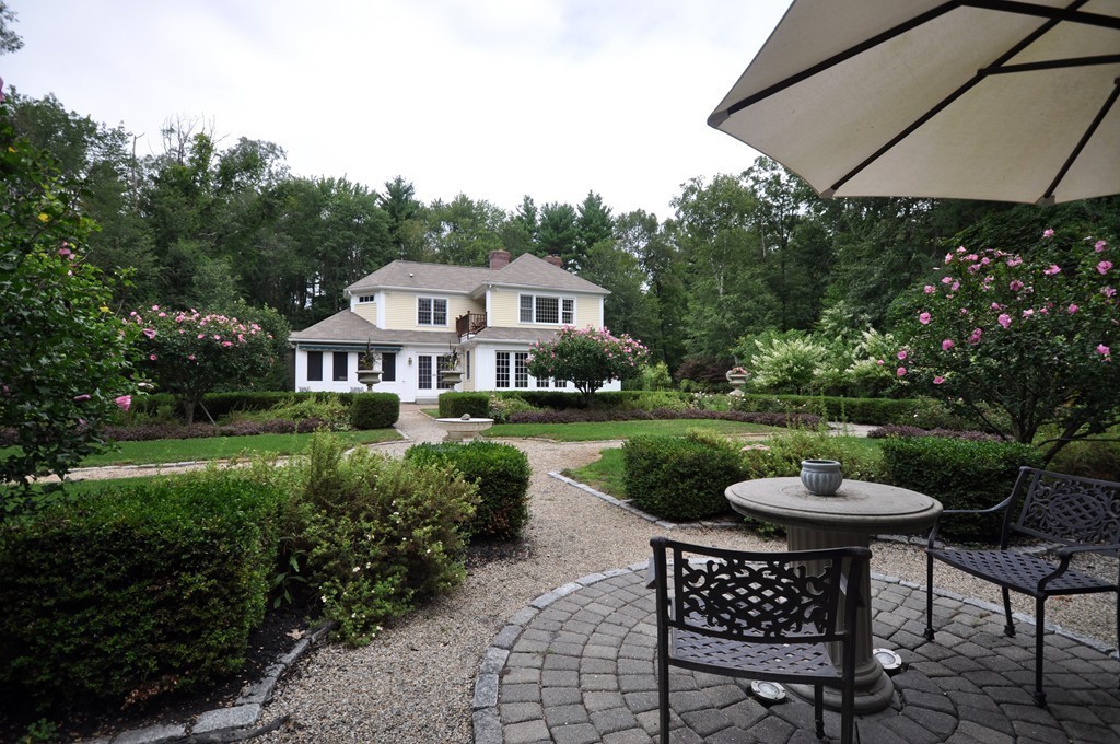 180 Pope Road Acton, MA 01720 - Photo 2 of 24 a front view of a house with a yard table and chairs