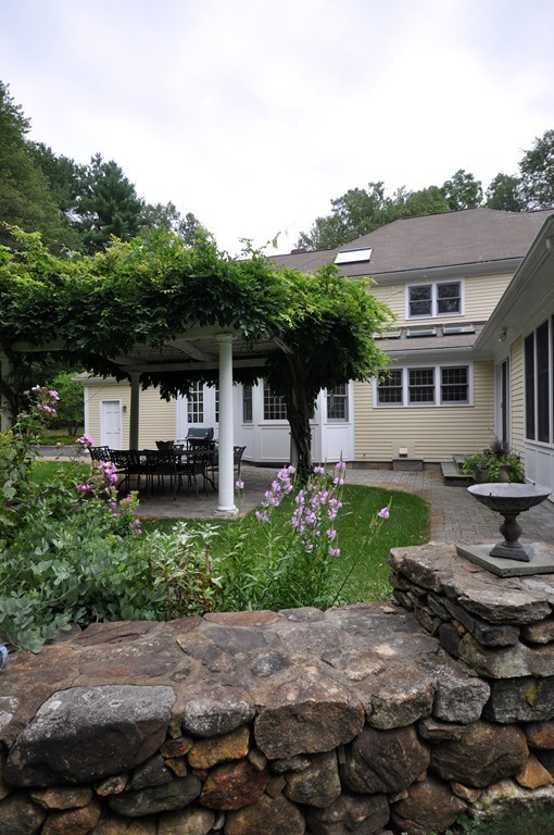 180 Pope Road Acton, MA 01720 - Photo 22 of 24 a front view of a house with garden