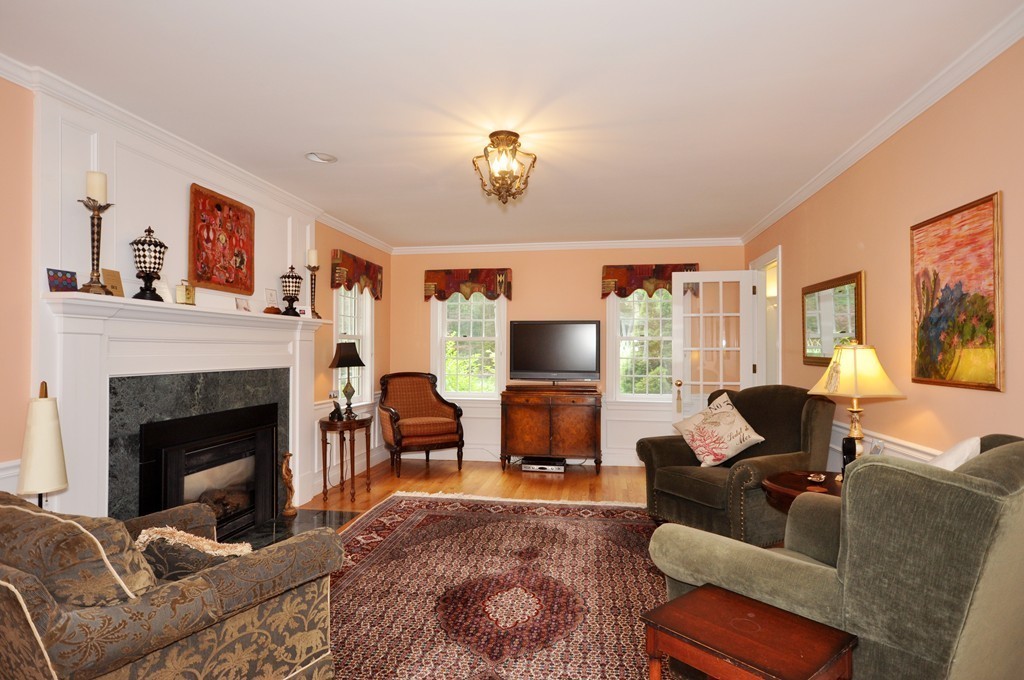 180 Pope Road Acton, MA 01720 - Photo 10 of 24 a living room with furniture a fireplace and a flat screen tv