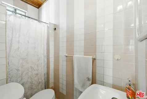 a bathroom with a toilet and shower
