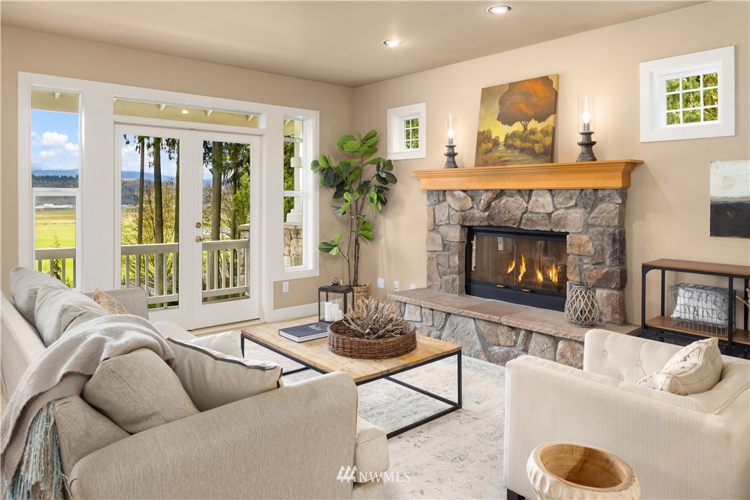 8707 West Snoqualmie Valley Road Northeast Carnation, WA 98014 - Photo 13 of 39 a living room with furniture and a fireplace