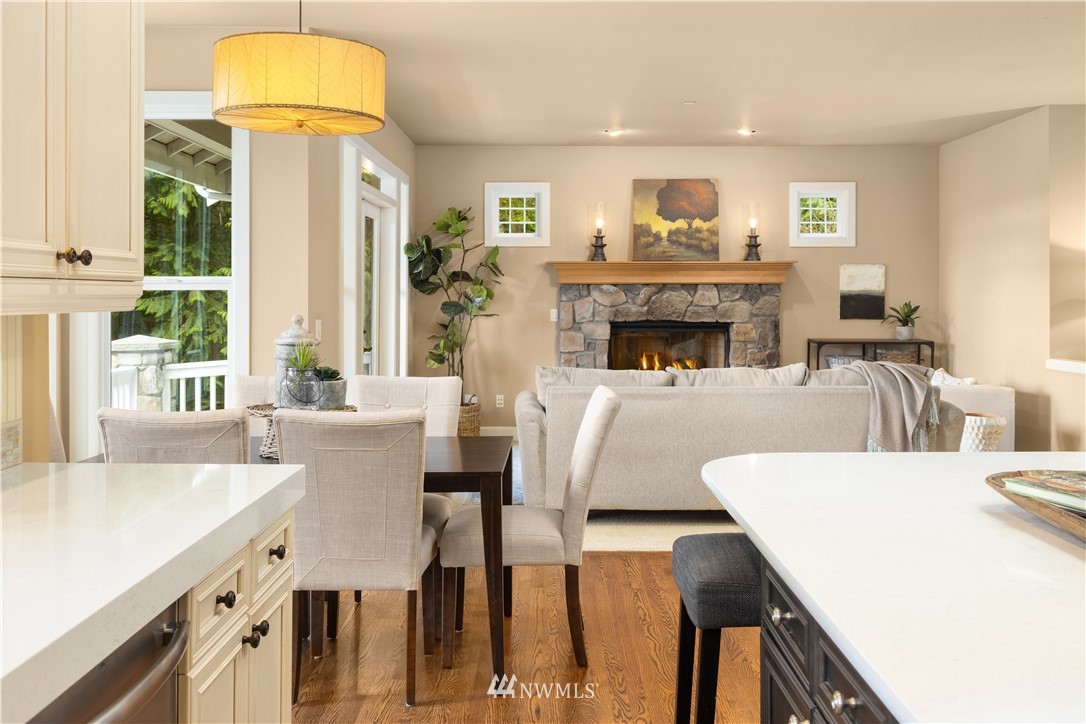 8707 West Snoqualmie Valley Road Northeast Carnation, WA 98014 - Photo 18 of 39 a living room with furniture a fireplace and a large mirror