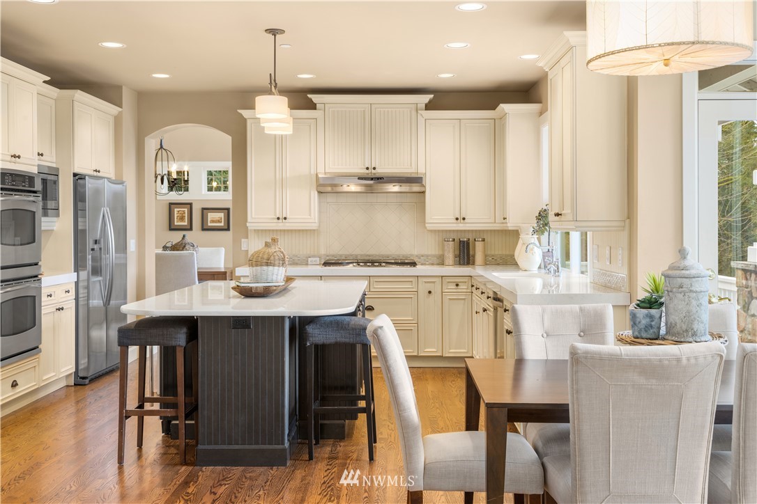 8707 West Snoqualmie Valley Road Northeast Carnation, WA 98014 - Photo 19 of 39 a large kitchen with a table and chairs