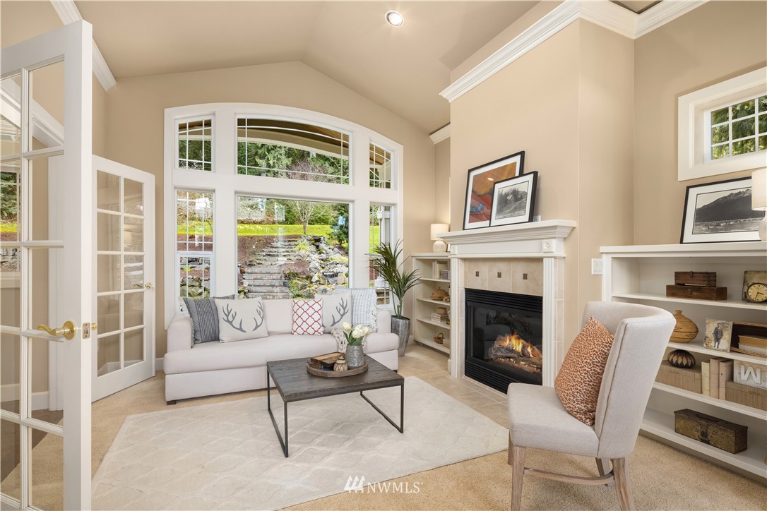 8707 West Snoqualmie Valley Road Northeast Carnation, WA 98014 - Photo 20 of 39 a living room with furniture and a fireplace