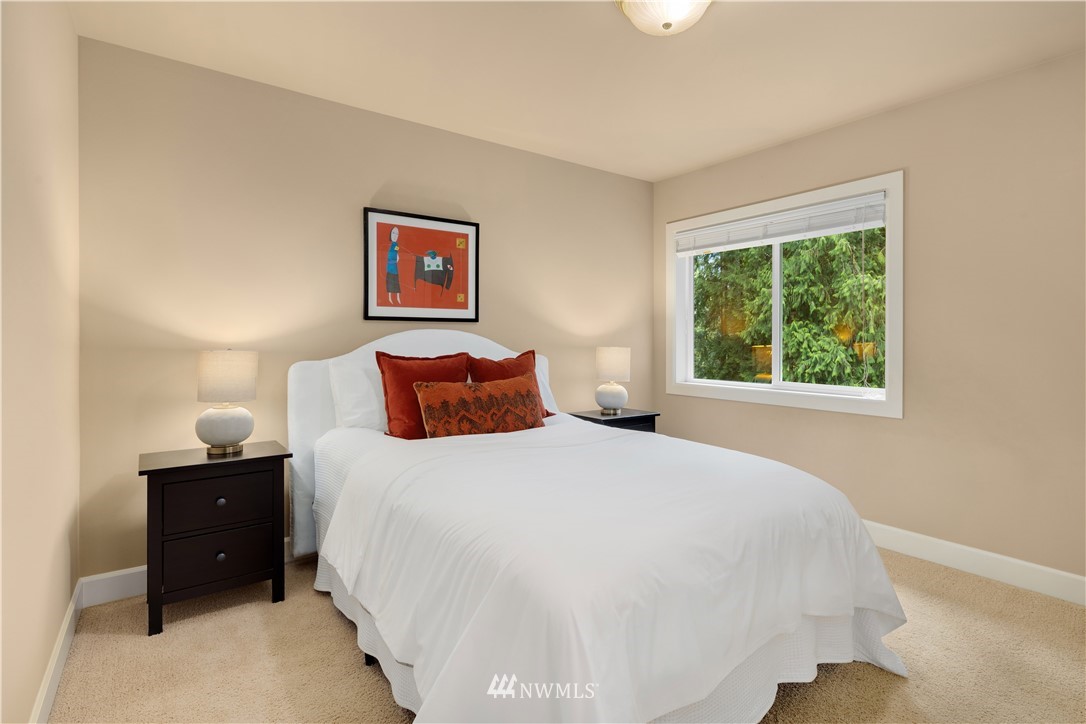 8707 West Snoqualmie Valley Road Northeast Carnation, WA 98014 - Photo 22 of 39 a bedroom with a bed and a painting on the wall