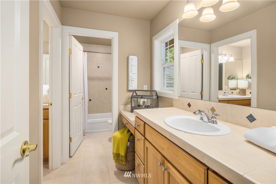 8707 West Snoqualmie Valley Road Northeast Carnation, WA 98014 - Photo 23 of 39 a en suite bathroom with a sink double vanity and a mirror