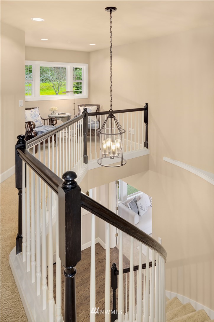 8707 West Snoqualmie Valley Road Northeast Carnation, WA 98014 - Photo 24 of 39 a view of a hallway with wooden floor and stairs