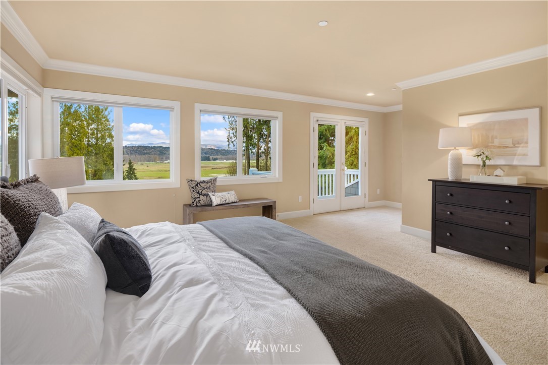 8707 West Snoqualmie Valley Road Northeast Carnation, WA 98014 - Photo 25 of 39 a large bed sitting in a bedroom and window