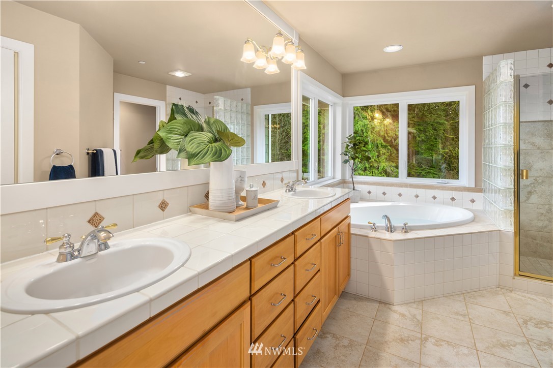 8707 West Snoqualmie Valley Road Northeast Carnation, WA 98014 - Photo 26 of 39 a bathroom with a tub sink and mirror