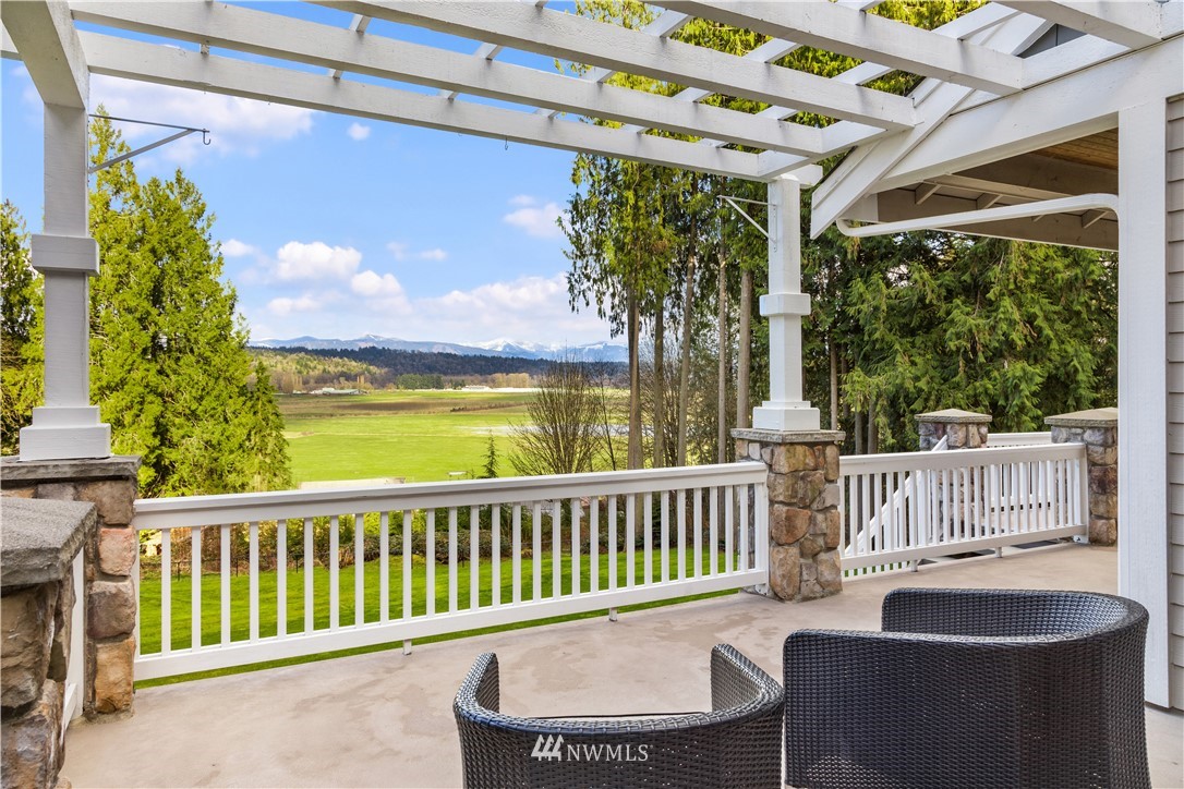 8707 West Snoqualmie Valley Road Northeast Carnation, WA 98014 - Photo 32 of 39 a view of a chairs and table on the deck