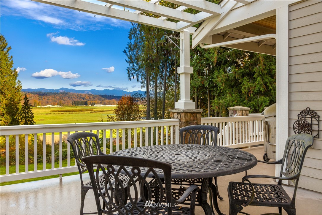 8707 West Snoqualmie Valley Road Northeast Carnation, WA 98014 - Photo 33 of 39 a view of a chair and table in the balcony